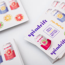 Stack of Spindrift sticker sheets with vinyl stickers